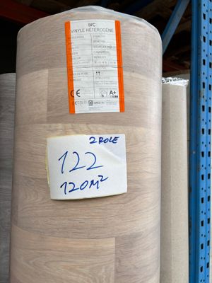 many rolls of fabric on the shelves in the store