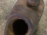 a rusted metal object on the ground on the ground