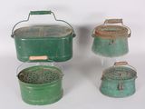 three green metal buckets with handles and handles on a white surface