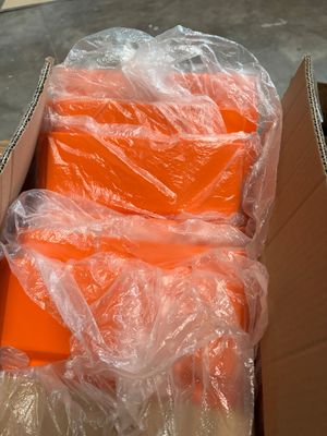 a box full of orange boxes sitting on the ground