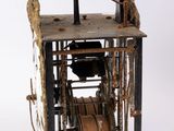 a small metal clock with a bell on top of it