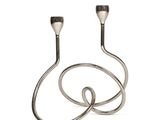two metal candles sitting on top of each other on a white surface