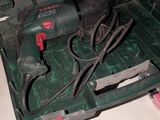 a green tool box with tools in it on a table