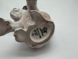 a figurine of a cat with a bird on it ' s back