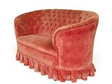 an image of a red couch with ruffles on it