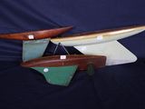 trois bateaux en bois exposés sur un fond noir