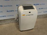 a white air conditioner sitting on the floor