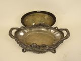 an antique silver plate with handles and handles on a white surface