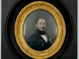 portrait of a man in a green coat and bow tie in a gold frame