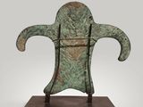 a bronze sculpture of a head on a wooden base
