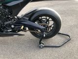 a black motorcycle that is parked in the parking lot