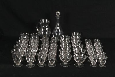 many glasses and a decanter on a black background