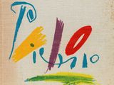 a close up of a book with a painting on it