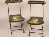 pair of folding chairs decorated with a painting of a woman and a cat
