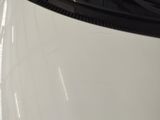 a close up of a white car in a showroom