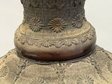 a large vase with carvings on it on a table