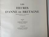 the book is open on a white table with a black and white picture