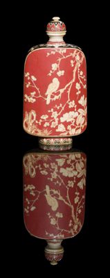 a red and white vase with a bird on it