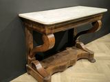 a wooden table with a marble top on a hard wood floor