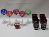 de nombreux verres à vin de différentes couleurs alignés sur une table