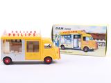 a yellow toy bus that is next to a box of ice cream