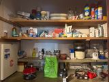 a kitchen with a lot of clutter on the shelves