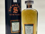 a bottle of whisky sitting next to a canister of whisky