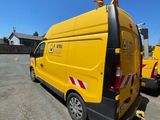 a yellow van that is parked in a parking lot