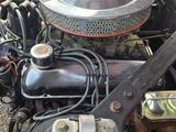a close up of a car ' s engine with the hood up
