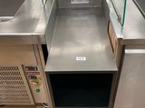 stainless steel sink and counter in a store with chairs in the background