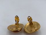 pair of gold plated earrings on a white surface
