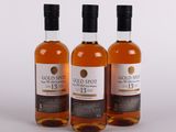 three bottles of gold spot whisky on a white background