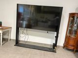 a flat screen tv sitting on a stand in a living room