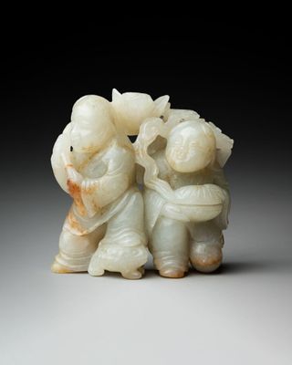 an image of a couple of figurines sitting on top of a table