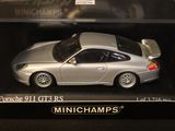 a silver toy car in a box on a table