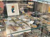 a glass display case with a lot of religious items on it