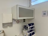 a television mounted on the wall above a washer and dryer