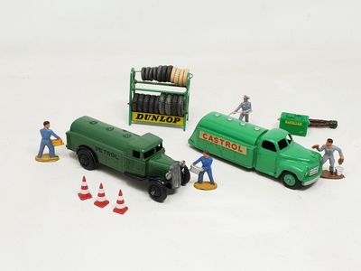 a green toy truck and a green toy truck and some construction workers