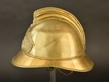 gold helmet on a metal stand with a black background