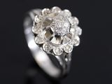 a close up of a diamond ring on a black surface
