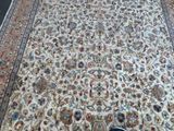 a person standing in front of a rug on the floor