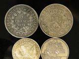four different coins sitting on top of each other on a table