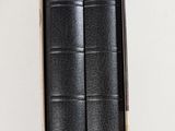 two books in a box on a white surface