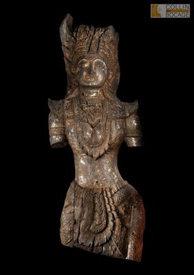 a close up of a statue on a black background with a black background