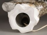 a white vase with a hole in it sitting on a table