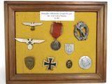 a picture of a shadow box with a lot of badges