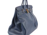 a blue leather handbag on a white background