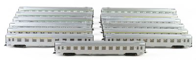 three white train cars sitting next to each other on a white surface