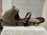 a baby stroller sitting on a table in front of a curtain