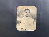 an old photo of a man in uniform posing for a picture